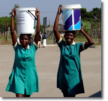 Women carrying water in buckets